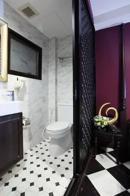 a bathroom with a toilet and a sink at Violet Tower at Khaosan Palace in Bangkok
