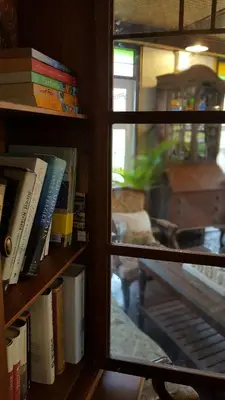 a window view of a book shelf with books at Villa Mungkala in Bangkok