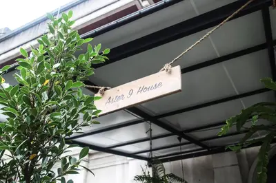 a sign hanging from the ceiling of a building at Aster 9 House in Bangkok