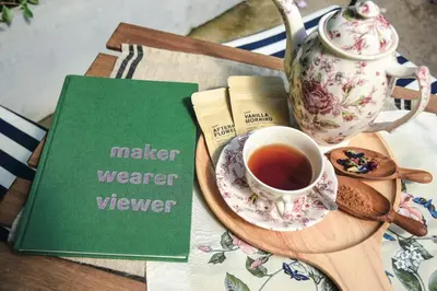 a teapot and a cup of tea on a wooden tray at Aster 9 House in Bangkok
