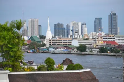 a view of a city with a river and buildings at Riva Arun Bangkok in Bangkok