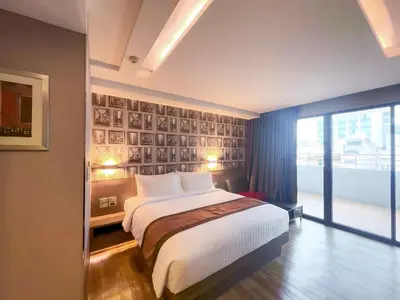 a bedroom with a bed and a large window at Aspira Sukhumvit in Bangkok