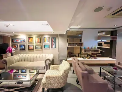 a salon with a waiting room with chairs and tables at Aspira Sukhumvit in Bangkok