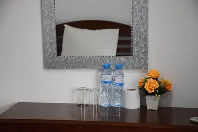 two bottles of water on a table with a mirror at Alsana Hotel in Bangkok
