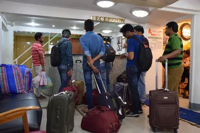 a group of people standing in a room with luggage at Alsana Hotel in Bangkok