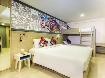 a bedroom with a bed and a bunk bed at Ibis Styles Bangkok Sukhumvit 50 in Bangkok