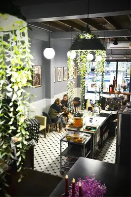 two people sitting in a room with plants at GOODFELLAS THONG LO HOSTEL #No check in after 5pm - Check in time needed# in Bangkok