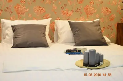 a white bed with a tray of books on it at GOODFELLAS THONG LO HOSTEL #No check in after 5pm - Check in time needed# in Bangkok
