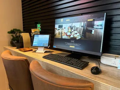 a desk with a computer monitor and a keyboard and mouse at Civic Horizon Hotel & Residence in Bangkok