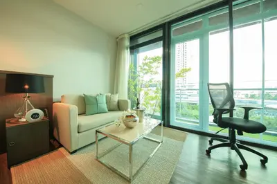 a living room with a couch and a chair at Civic Horizon Hotel & Residence in Bangkok