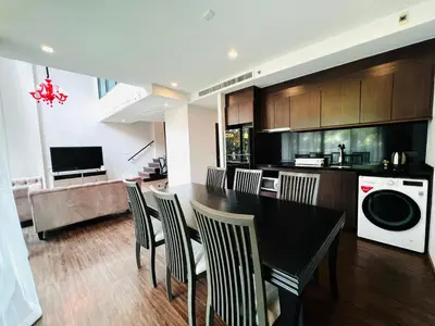 a kitchen and living room with a table and chairs at Civic Horizon Hotel & Residence in Bangkok