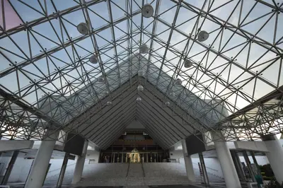 a large glass ceiling of a building with a staircase at Blissotel Ratchada in Bangkok