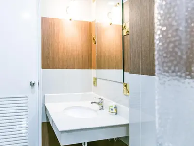 a bathroom with a sink and a mirror at Sunset Residence Pinklao in Bangkok
