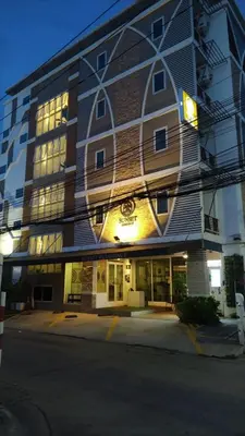 a large building with a lit up facade at Sunset Residence Pinklao in Bangkok