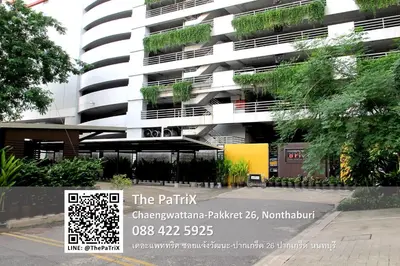 a building with a sign in front of it at The PaTriX Chaengwattana in Nonthaburi