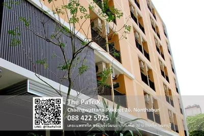 a building with a tree in front of it at The PaTriX Chaengwattana in Nonthaburi