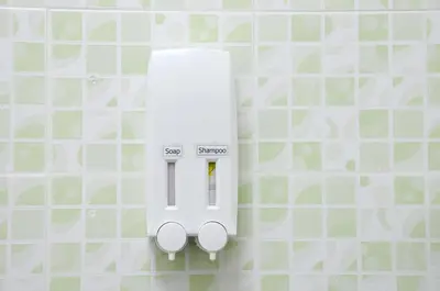 a white electric meter on a tiled wall at The Backpacker stn in Nonthaburi
