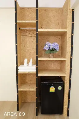 a closet with a black refrigerator in a room at Area 69 (Don Muang Airport) in Bangkok