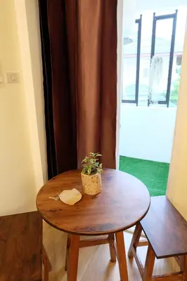 a wooden table with a potted plant on top of it at Area 69 (Don Muang Airport) in Bangkok