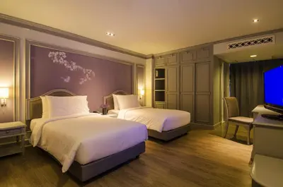 a hotel room with two beds and a flat screen tv at imm hotel Ladprao Bangkapi Bangkok in Bangkok