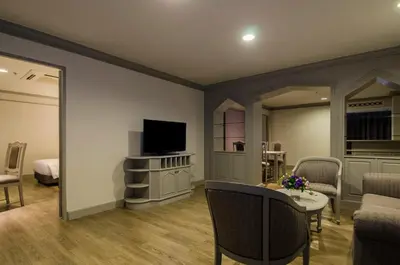 a living room with a tv and a couch and a table at imm hotel Ladprao Bangkapi Bangkok in Bangkok