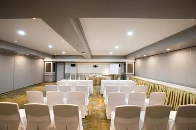 a conference room with white chairs and a podium at imm hotel Ladprao Bangkapi Bangkok in Bangkok