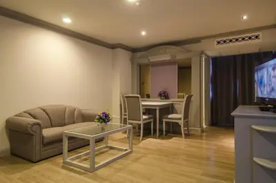 a living room with a couch and a table at imm hotel Ladprao Bangkapi Bangkok in Bangkok