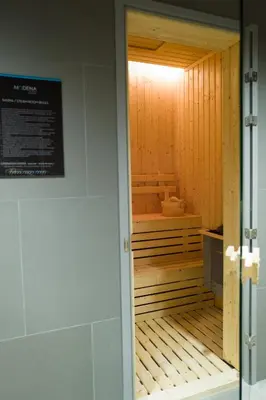 a sauna inside of a room with a door at Modena by Fraser Bangkok in Bangkok