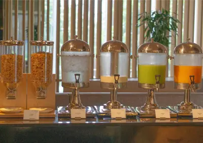 a display of different types of drinks on a counter at Modena by Fraser Bangkok in Bangkok