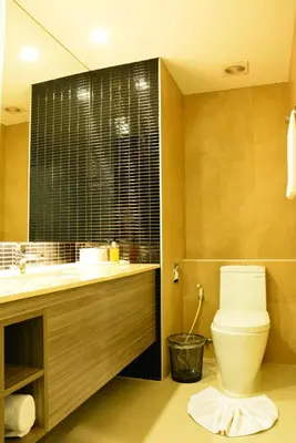 a bathroom with a toilet and a sink at Trinity Silom Hotel in Bangkok