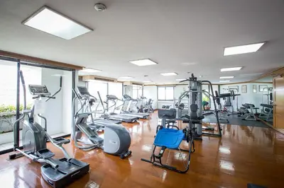 a gym with treadmills and elliptical machines at Trinity Silom Hotel in Bangkok