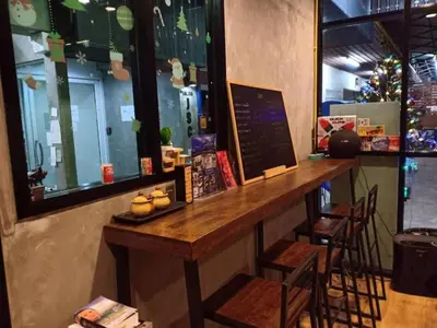 a bar in a restaurant with a table and chairs at Room58 in Bangkok