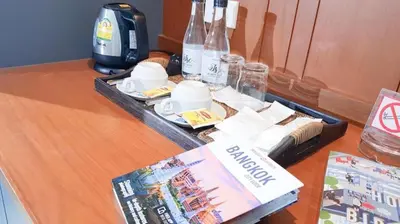 a tray with cups and plates on a table at Room58 in Bangkok