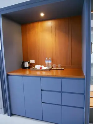 a kitchen with wooden cabinets and a counter top at Room58 in Bangkok