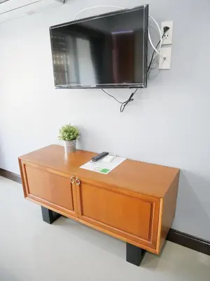 a flat screen tv on top of a wooden table at Room58 in Bangkok