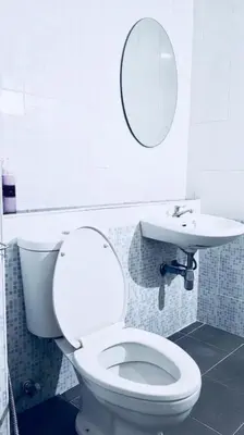 a bathroom with a white toilet and a sink at Room58 in Bangkok