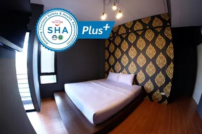 a bed in a room with a sign that reads shha plus at Hide Bangkok Hostel in Bangkok