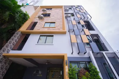 a facade of a building with many windows at Hide Bangkok Hostel in Bangkok