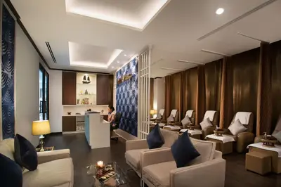 a waiting room with couches and chairs and a table at Somerset Ekamai Bangkok in Bangkok