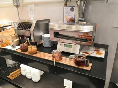 a kitchen with a counter with donuts on at Grande Centre Point Sukhumvit 55 Thong Lo in Bangkok