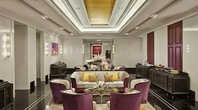 a living room with a couch and a table and chairs at Grande Centre Point Sukhumvit 55 Thong Lo in Bangkok