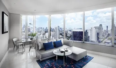 a living room with a couch and a large window at Grande Centre Point Sukhumvit 55 Thong Lo in Bangkok