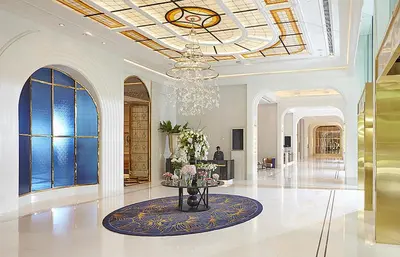a lobby with a chandelier and a table with flowers at Grande Centre Point Sukhumvit 55 Thong Lo in Bangkok