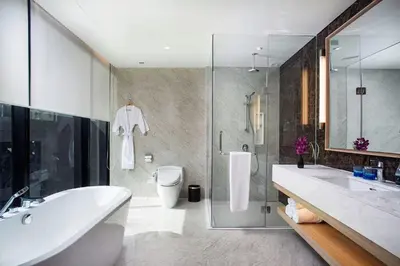 a bathroom with a tub and a toilet and a sink at SKYVIEW Hotel Bangkok - Sukhumvit in Bangkok