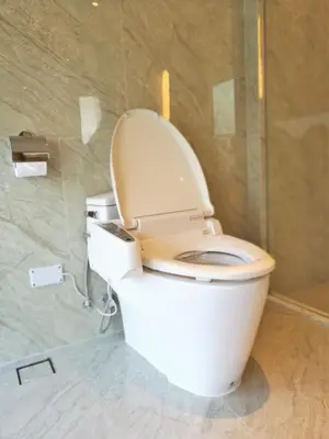 a white toilet in a bathroom with a shower at SKYVIEW Hotel Bangkok - Sukhumvit in Bangkok