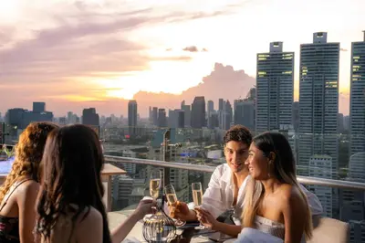 a group of women sitting at a table on the roof of a building at SKYVIEW Hotel Bangkok - Sukhumvit in Bangkok