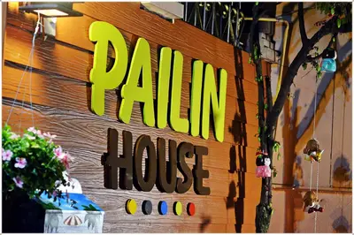 a sign on the side of a rain house at Pailin Guest House in Bangkok