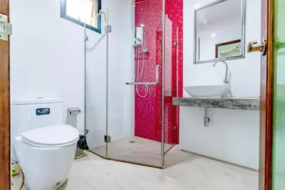 a bathroom with a toilet and a sink at The Pool Resort in Bangkok
