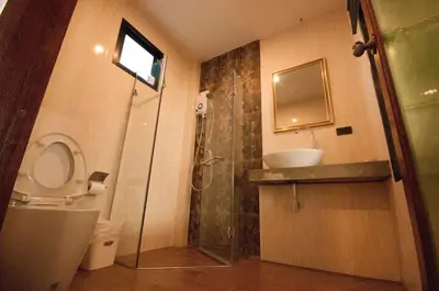 a bathroom with a shower and a toilet and a sink at The Pool Resort in Bangkok