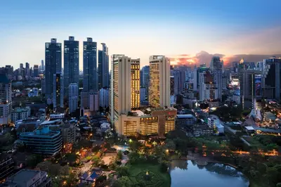 a city skyline at night with tall buildings at Bangkok Marriott Marquis Queens Park in Bangkok